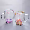 Stylish Jiateng double-layer glass cups, showcasing vibrant dried flowers, ideal for enjoying hot milk tea or iced beverages.