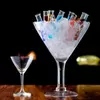 Stylish large V-shaped martini glass with colorful drinks and ice presentation