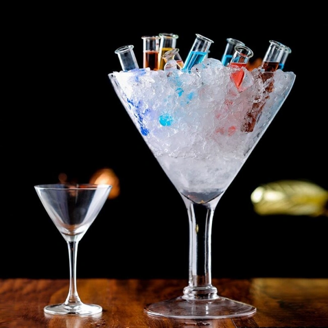 Stylish large V-shaped martini glass with colorful drinks and ice presentation