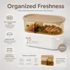 Top view of oval food storage container with beige lid measuring 22.4cm long and 11.2cm wide