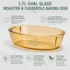 Top view of a 28.5cm long amber oval glass baking dish with integrated handles and a smooth interior.