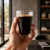 Modern 300ml double wall coffee glass filled with dark coffee and a golden crema layer
