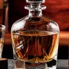 Clear rounded whiskey decanter featuring a geometric glass stopper
