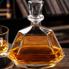 Angular glass whiskey decanter featuring a decorative geometric stopper