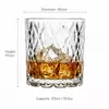 Clear geometric whiskey glass with decorative mountain inspired texture
