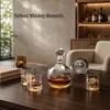 Round decorative whiskey decanter featuring a clear glass ball stopper