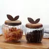 Stylish modern glass kitchen storage jar with decorative wooden leaf top
