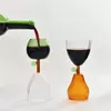 Elegant glass cups shaped like fruits with a leafy stem, ideal for special occasions and decorative serving
