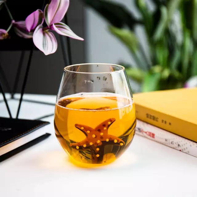 Front view of 3D starfish glass cup with beverage