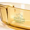 Transparent amber oval glass oven dish measuring 38.3 by 27.6 by 7.0cm with a spacious interior and rounded edges.