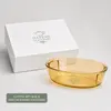 Side view of a shallow amber borosilicate glass baking dish measuring 5.7cm in height.