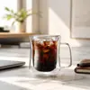 Transparent handled coffee mug featuring a rounded inner wall and double wall construction