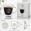 Modern transparent double wall coffee mug filled with dark coffee and a golden crema layer