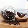 Premium glass food storage jar featuring a natural wooden leaf lid for modern kitchens