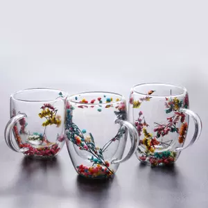 Jiateng double-wall insulated glass cups with real dried flowers inside, perfect for serving milk tea or herbal tea.