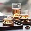 Elegant cocktail and whiskey glass with mountain design and wooden coaster base