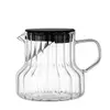 Transparent glass coffee brewing pitcher with textured ribbed design and spout