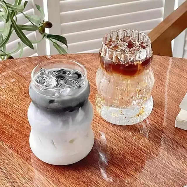 Modern wave ribbed glass cup filled with iced coffee on a clean tabletop