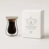 Clear borosilicate double wall espresso glass filled with dark coffee and crema for specialty cafe beverage presentation