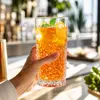 Tall decorative highball glass with geometric pattern for cocktails iced tea and mixed drinks