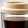 Small 250ml glass coffee cup featuring a cream silicone lid and transparent double wall body