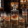 Decorative whiskey serving set with patterned decanter and four matching glasses