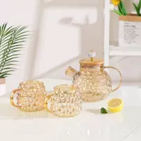 Elegant vintage diamond glass cold water pitcher with matching glass cups for modern home beverage serving