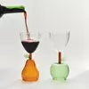 Creative clear glass cups with apple and pear bases, designed for cocktails, juices, and tea, perfect for modern home décor