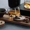 Unique bourbon glass tumbler with mountain-shaped bottom for modern drinkware collections