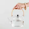 Japanese inspired clear glass teapot with smooth pouring spout and wooden handle