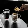 Transparent borosilicate glass tea cup with ergonomic handle design