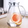 BPA-free borosilicate glass pitcher with stainless steel lid, filled with water and fresh grapefruit slices, demonstrating professional-grade clarity and durability.