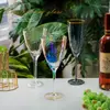 Decorative iridescent wine glasses displayed with modern table setting and wine bottle