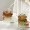 Stylish ribbed glass tumbler holding layered iced latte drink