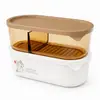 1060ml oval divided food storage container with beige lid transparent amber compartment white base and removable inner drain tray