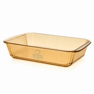 1.3L amber rectangular borosilicate glass baking dish with vertical fluted texture and integrated side handles for oven cooking.