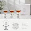 Clear rounded brandy glasses with short stems and circular footed bases