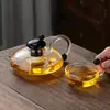 Contemporary flat glass teapot with artistic curved handle for home and tea house use