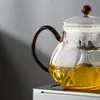 Crystal-clear glass teapot with integrated glass infuser for professional tea brewing