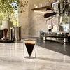 Unique espresso glass featuring a pointed conical inner chamber surrounded by a transparent outer wall